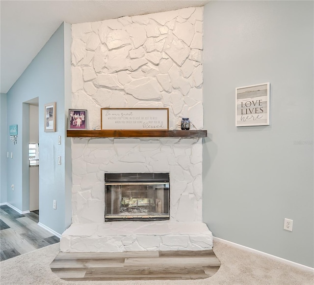 room details featuring a fireplace and carpet