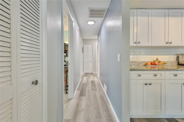 hall with light wood-type flooring