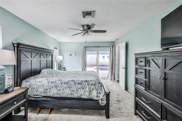 bedroom featuring ceiling fan, access to exterior, light carpet, and a textured ceiling