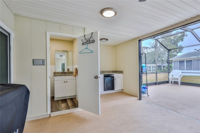 view of patio / terrace featuring a lanai and sink