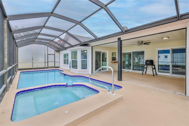 view of pool with a patio and glass enclosure