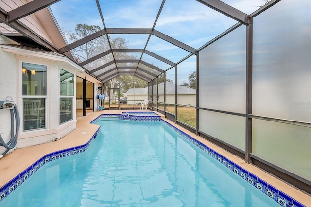 view of pool featuring an in ground hot tub, a lanai, and a patio area