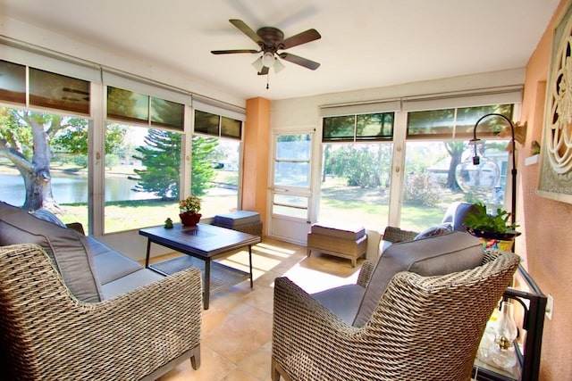 sunroom with a water view and ceiling fan