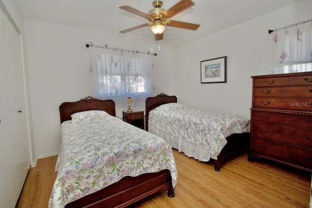 bedroom with a closet, ceiling fan, and light hardwood / wood-style flooring