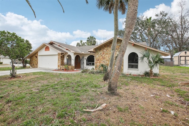 view of front of home with a garage, concrete driveway, stone siding, a front yard, and stucco siding