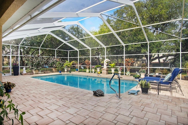 view of swimming pool with a patio area and glass enclosure