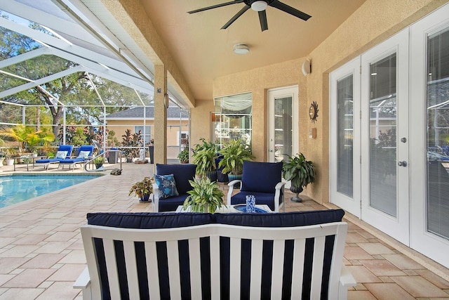 view of patio / terrace with outdoor lounge area, glass enclosure, ceiling fan, and french doors