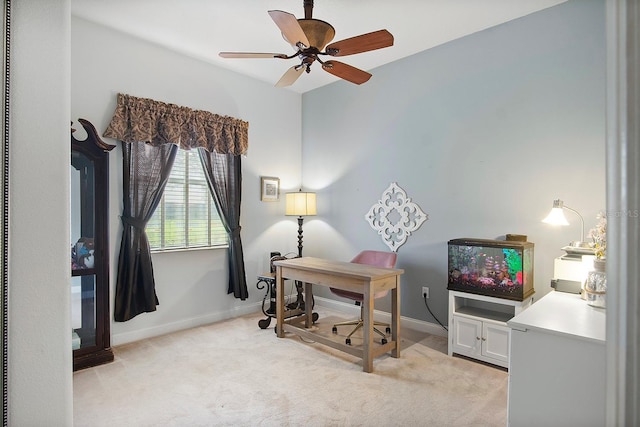 home office featuring light carpet and ceiling fan