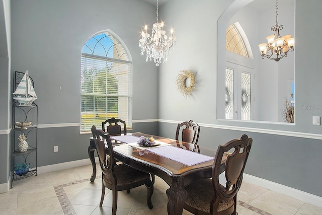 dining space with a notable chandelier and a towering ceiling