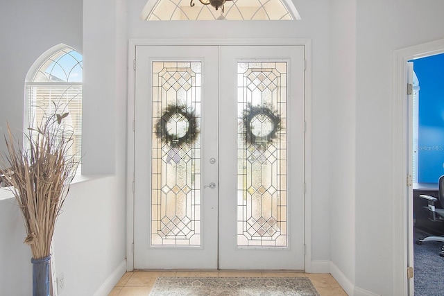 tiled entrance foyer featuring french doors