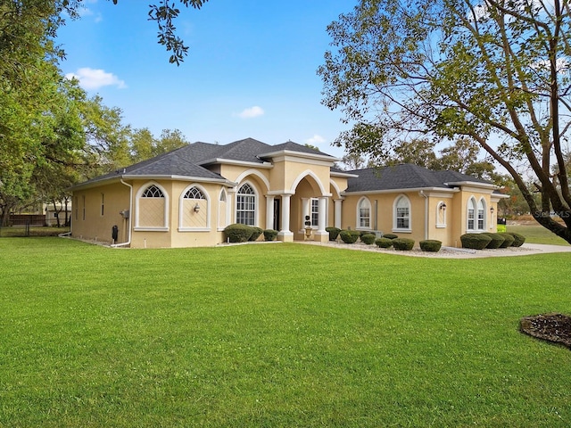 mediterranean / spanish house featuring a front lawn