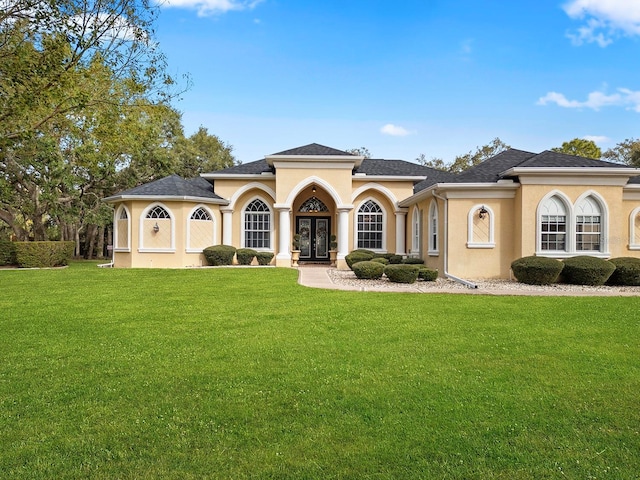 view of front of home featuring a front lawn and french doors