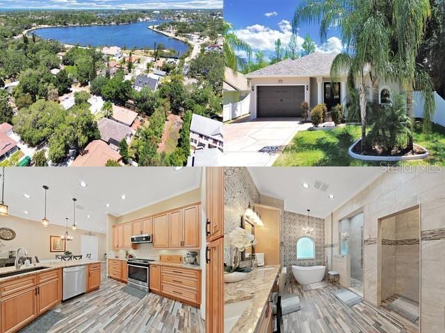 exterior space with extractor fan, sink, a water view, pendant lighting, and stainless steel appliances