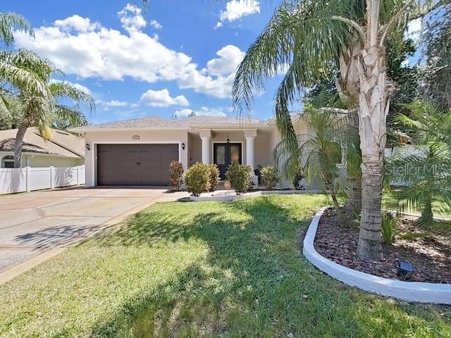 view of front of house featuring a garage and a front lawn