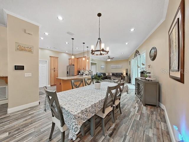 dining room featuring crown molding, ceiling fan, and hardwood / wood-style floors