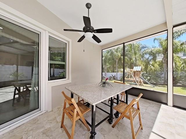 sunroom with ceiling fan