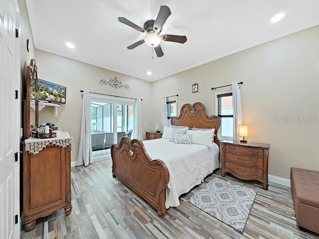 bedroom featuring multiple windows, ceiling fan, and light hardwood / wood-style floors