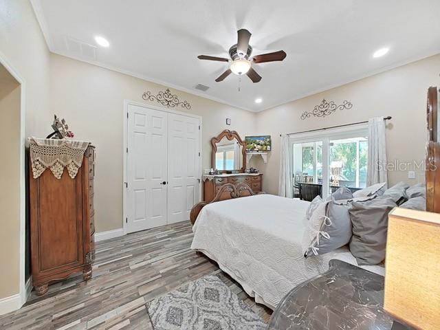 bedroom with hardwood / wood-style floors, access to outside, a closet, and ceiling fan