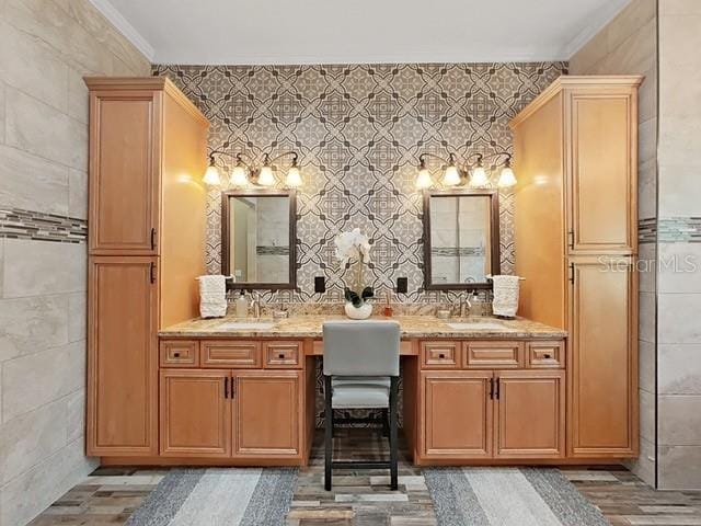 bathroom with vanity, ornamental molding, and tile walls