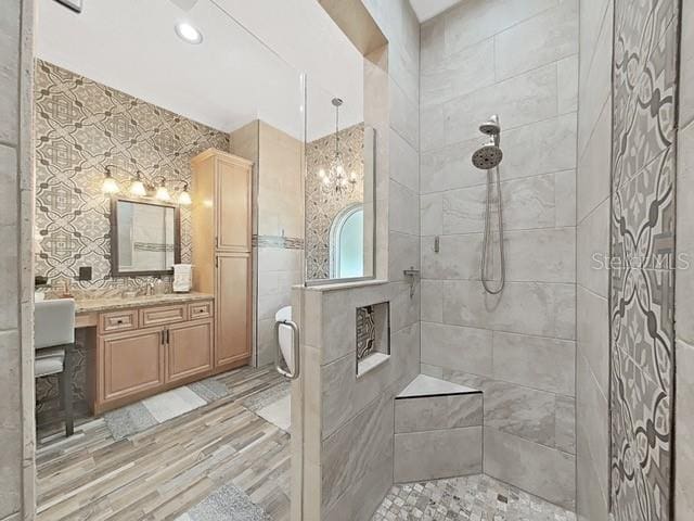 bathroom featuring walk in shower and vanity