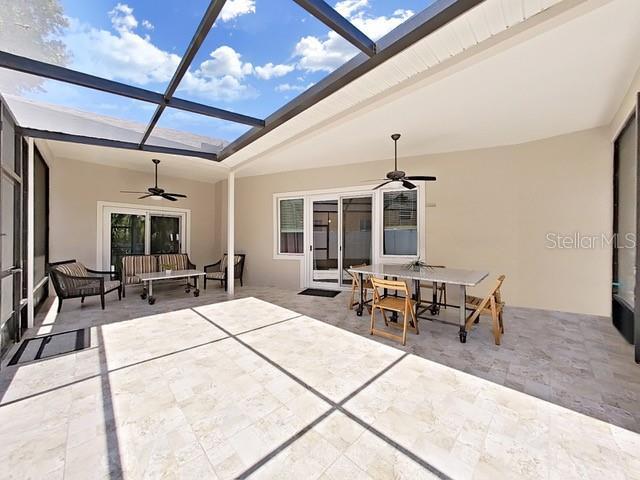 view of patio / terrace with a lanai and ceiling fan