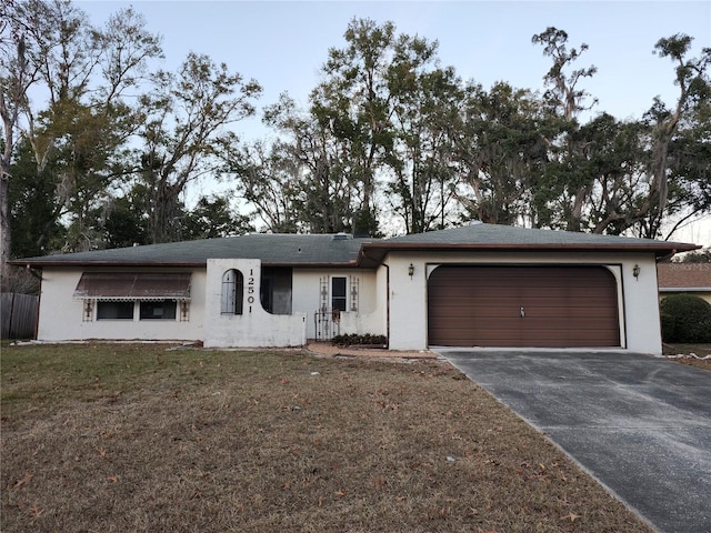 single story home with a garage and a front yard