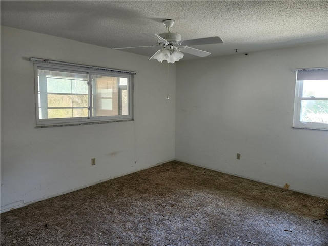 unfurnished room with a textured ceiling, carpet floors, and a ceiling fan