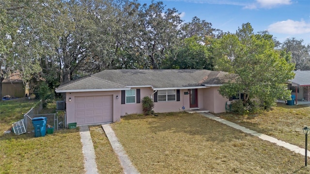 ranch-style house with a garage and a front yard