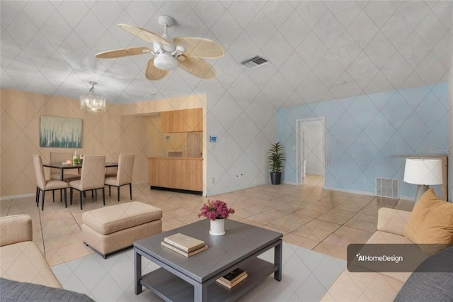 living room featuring tile patterned flooring and ceiling fan with notable chandelier