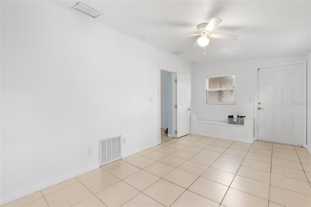 unfurnished room featuring light tile patterned floors and ceiling fan