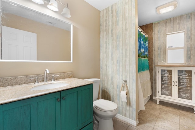 bathroom with a shower with curtain, vanity, tile patterned floors, and toilet