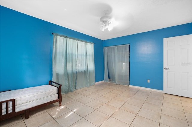 tiled bedroom with ceiling fan