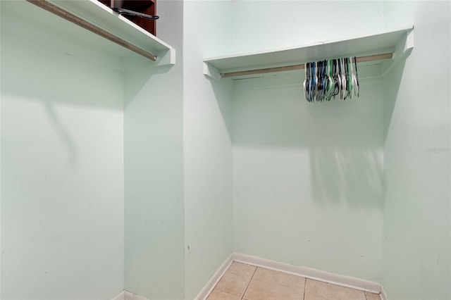 spacious closet with light tile patterned floors