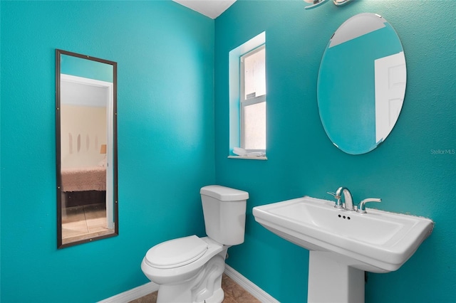 bathroom featuring toilet and sink