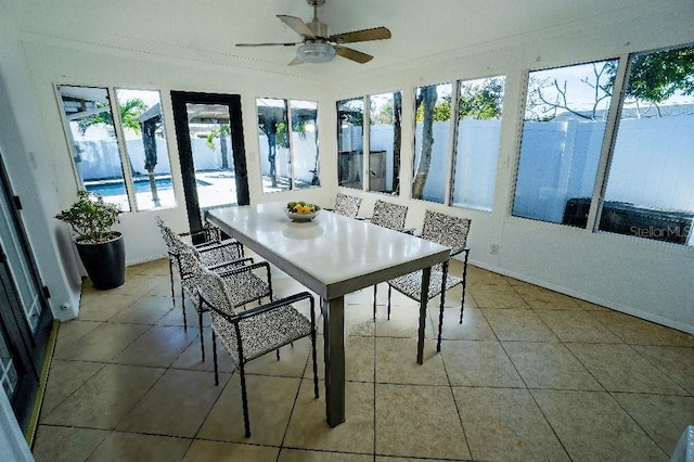 unfurnished sunroom with ceiling fan