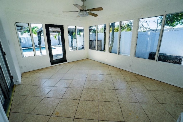 unfurnished sunroom featuring plenty of natural light and ceiling fan