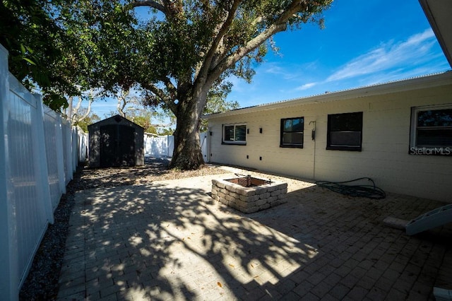 exterior space with an outdoor fire pit and a shed