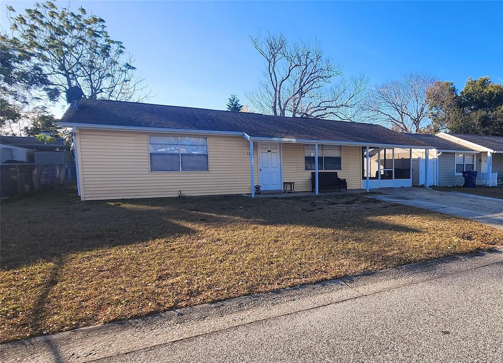 single story home with a carport and a front yard