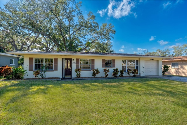 ranch-style house with a garage and a front lawn