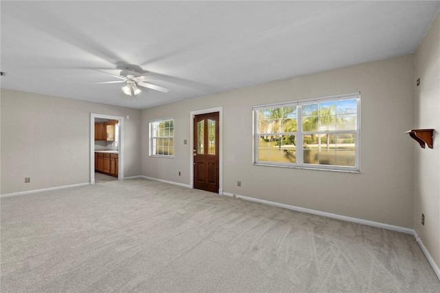 carpeted empty room with ceiling fan