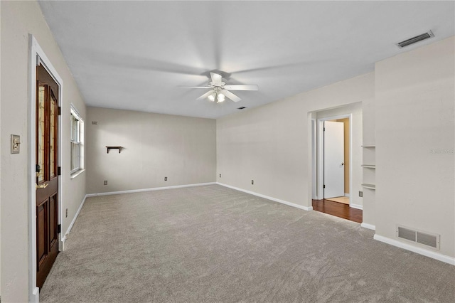 empty room with carpet flooring and ceiling fan