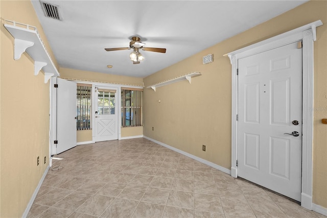 spare room with light tile patterned flooring and ceiling fan