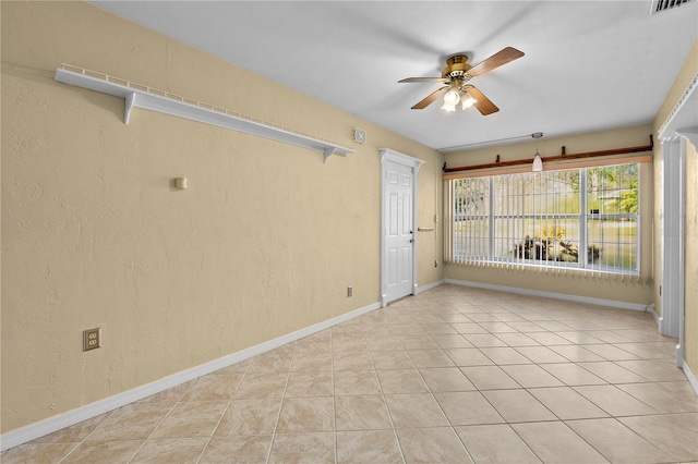 tiled empty room with ceiling fan