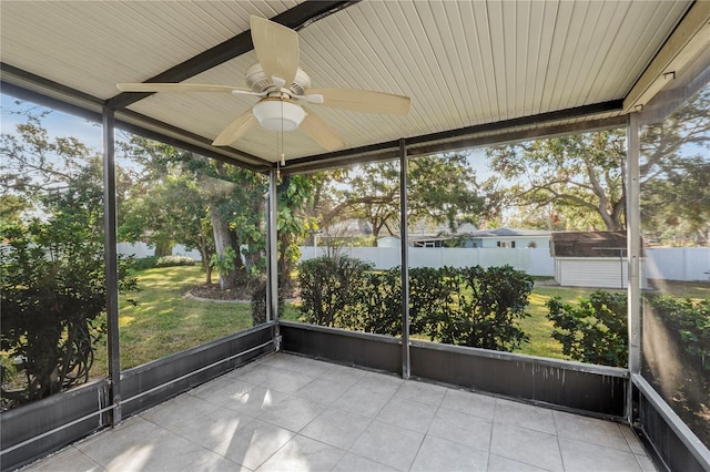 unfurnished sunroom featuring a wealth of natural light and ceiling fan