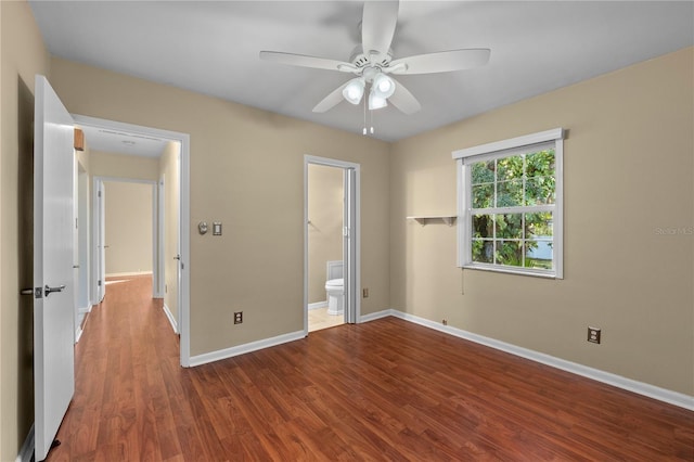 unfurnished bedroom featuring hardwood / wood-style flooring, ceiling fan, and ensuite bath