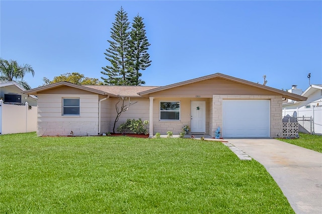 ranch-style home featuring a garage and a front yard