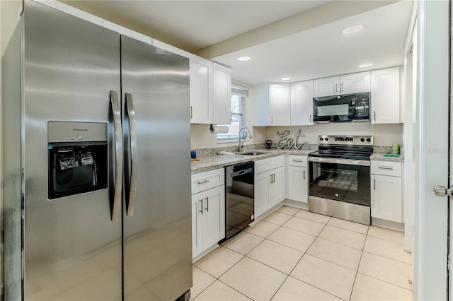 kitchen with light tile patterned floors, sink, light stone countertops, black appliances, and white cabinets