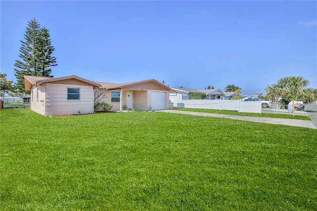 view of front of house featuring a garage and a front lawn