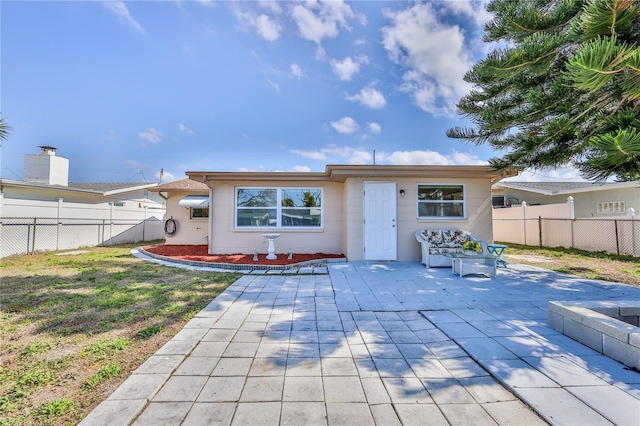 back of property featuring a lawn and a patio area