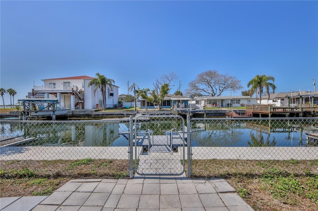 exterior space featuring a boat dock and a water view